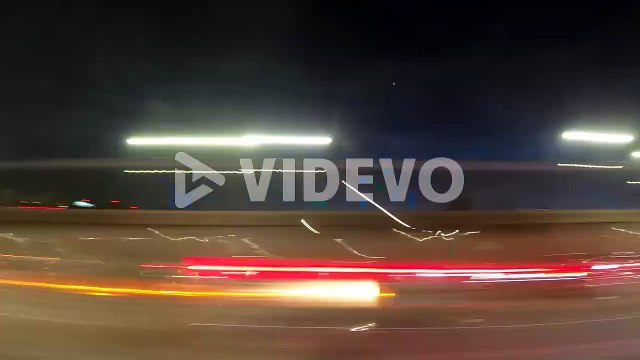 Driving through the city under the blue night sky - time lapse