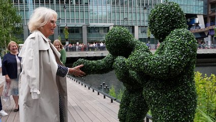 Bizarre moment Queen Camilla meets people dressed as bushes
