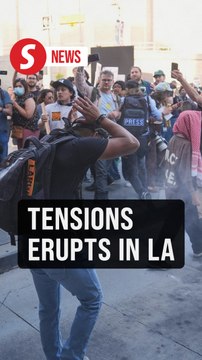 Tear gas fills LA streets as protesters clash with police following ICE raids