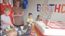 Comical birthday moment as lad falls off bench before blowing out cake candles
