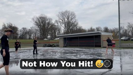 Girl tries to hit a wiffle ball but her bat goes flying in the air
