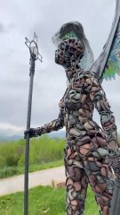 Glass winged goddess made from steel and stone