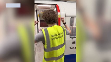 Angry friends removing graffiti from Bakerloo line Tube trains