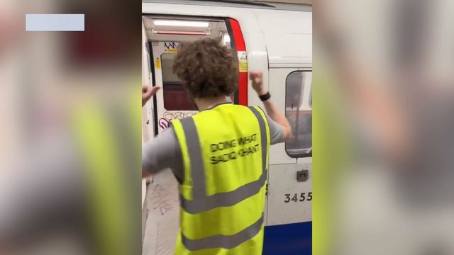 Angry friends removing graffiti from Bakerloo line Tube trains