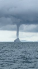 Massive Water Tornado Visible Over Sea From Boat