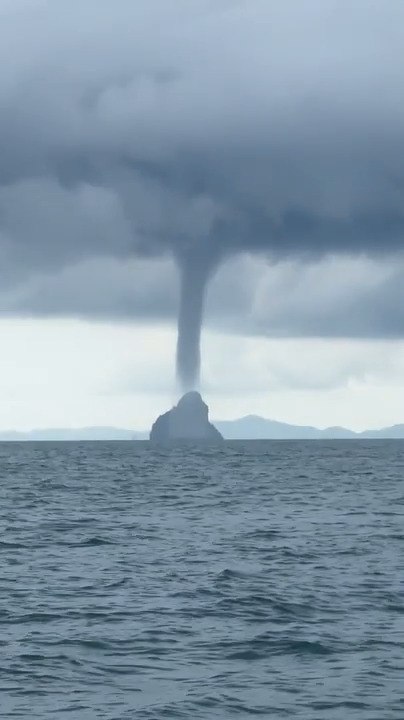 Massive Water Tornado Visible Over Sea From Boat