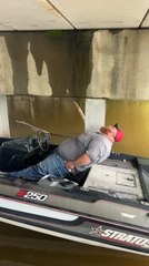 Man Sleeps on Boat Under Bridge During Storm
