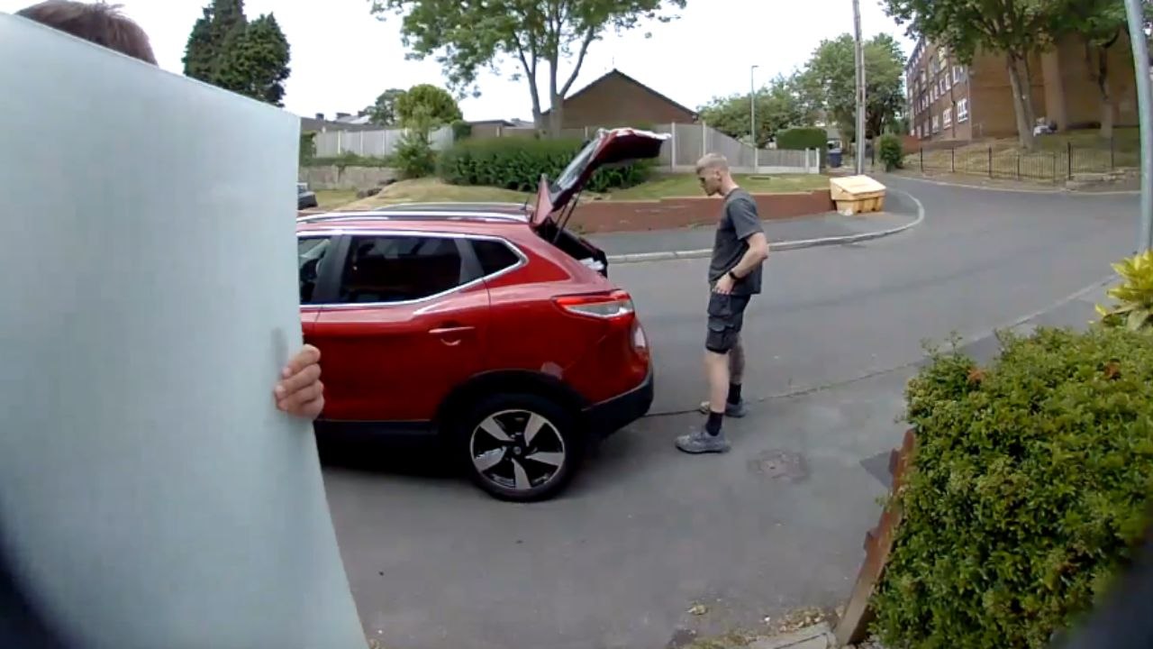 Doorbell camera captures the moment a glass panel shatters while man is holding it