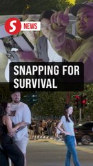 'Selfie men' hustle at twin towers