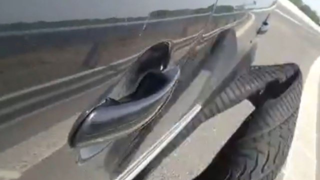 Damaged tire wobbles on highway as man pushes ahead to reach a gas station