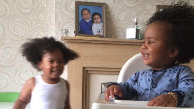 Little boys burst into giggles after one slaps the other with a nappy
