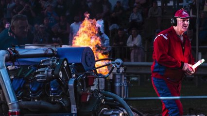 Black skies and flaming engines at tractor pulling event