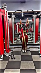 A Desi girl in a sari is working out at the gym.