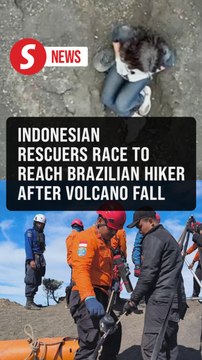Indonesian rescuers work to reach Brazilian hiker after volcano cliff fall