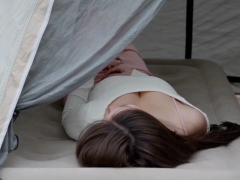 Solo girl camping alone relaxing in nature