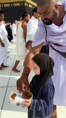 Cute baby in Makkah distributing dates to other muslims.