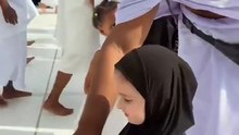 Cute baby in Makkah distributing dates to other muslims.