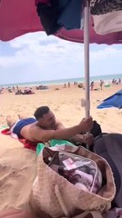 Gusty Beach Winds Cause Umbrellas to Take Flight