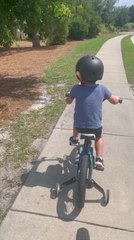 Child Grumbles About Getting Too Sweaty While Biking Outdoors