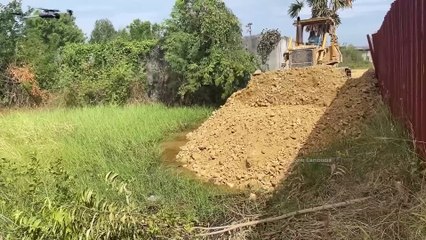 An Old Strong Dozer Pushing Rock Soil Filling Sink Hole & 25T Trucks