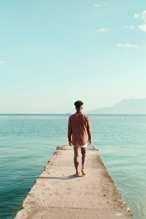 Alone & Sad ||  a person gently walking along a Mexican jetty.