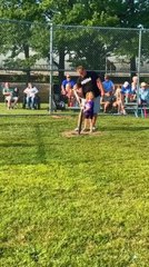 Young Girl Struggles at Bat and Trips in Frustration