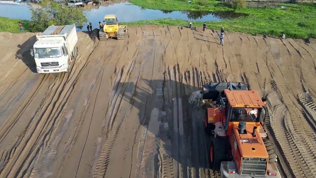 Wonderful Bulldozer SHANTHUI Showing Talent Skill Moving Sand into water with Dump truck unloading