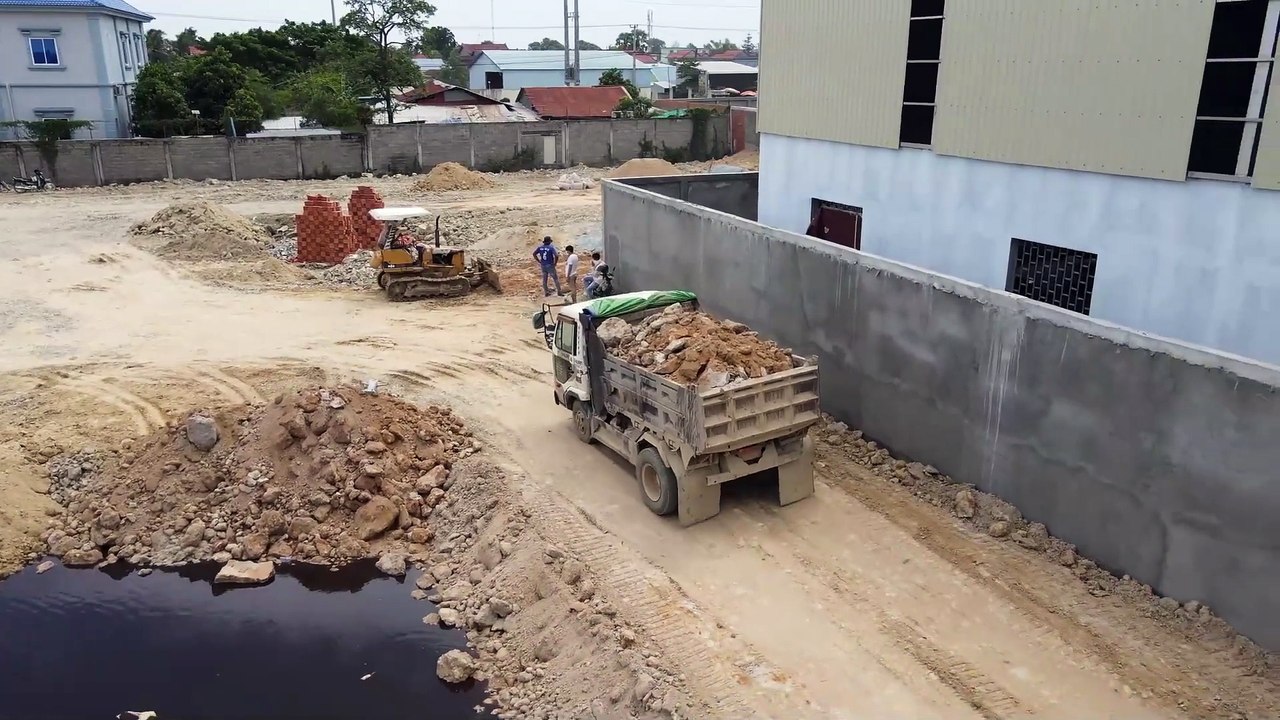 Amazing Nice Action Building New Road on border by dump truck Spreading stone soil with dozer d20p