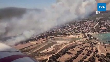 Çeşme'de makilik alanda çıkan yangına müdahale ediliyor