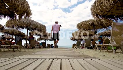 Umbrella and sunbeds at beach bar in Greece 3