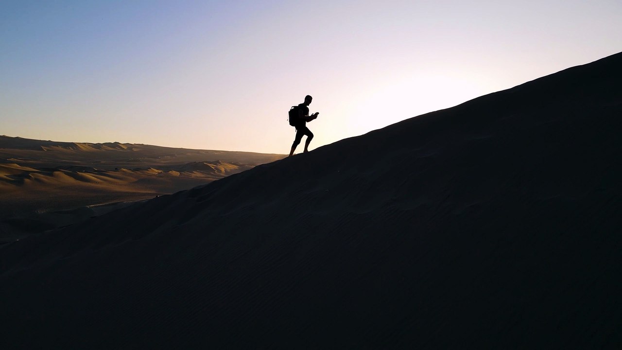 Sunrise Hike Across Vast Desert Dunes