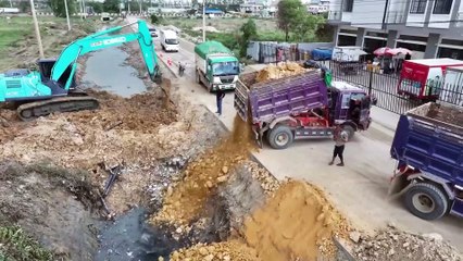 This video shows the construction of a road and the dump truck falling into a deep ditch.