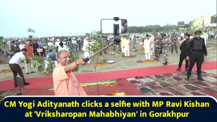CM Yogi Adityanath clicks a selfie with MP Ravi Kishan at 'Vriksharopan Mahabhiyan' in Gorakhpur