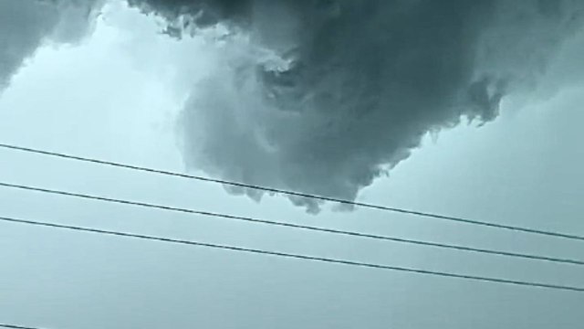 Powerful tornado begins to form over shop as fearless man records the ominous scene