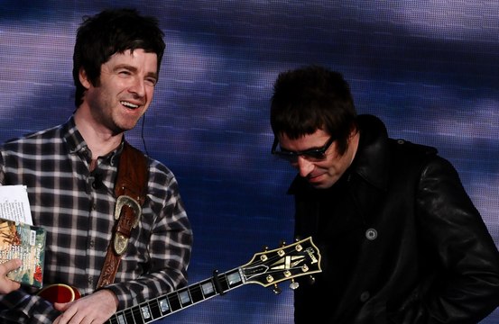 Oasis: Liam and Noel Gallagher use paper straws to warm up their vocals
