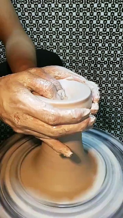 Picking a bottle out of the mud.