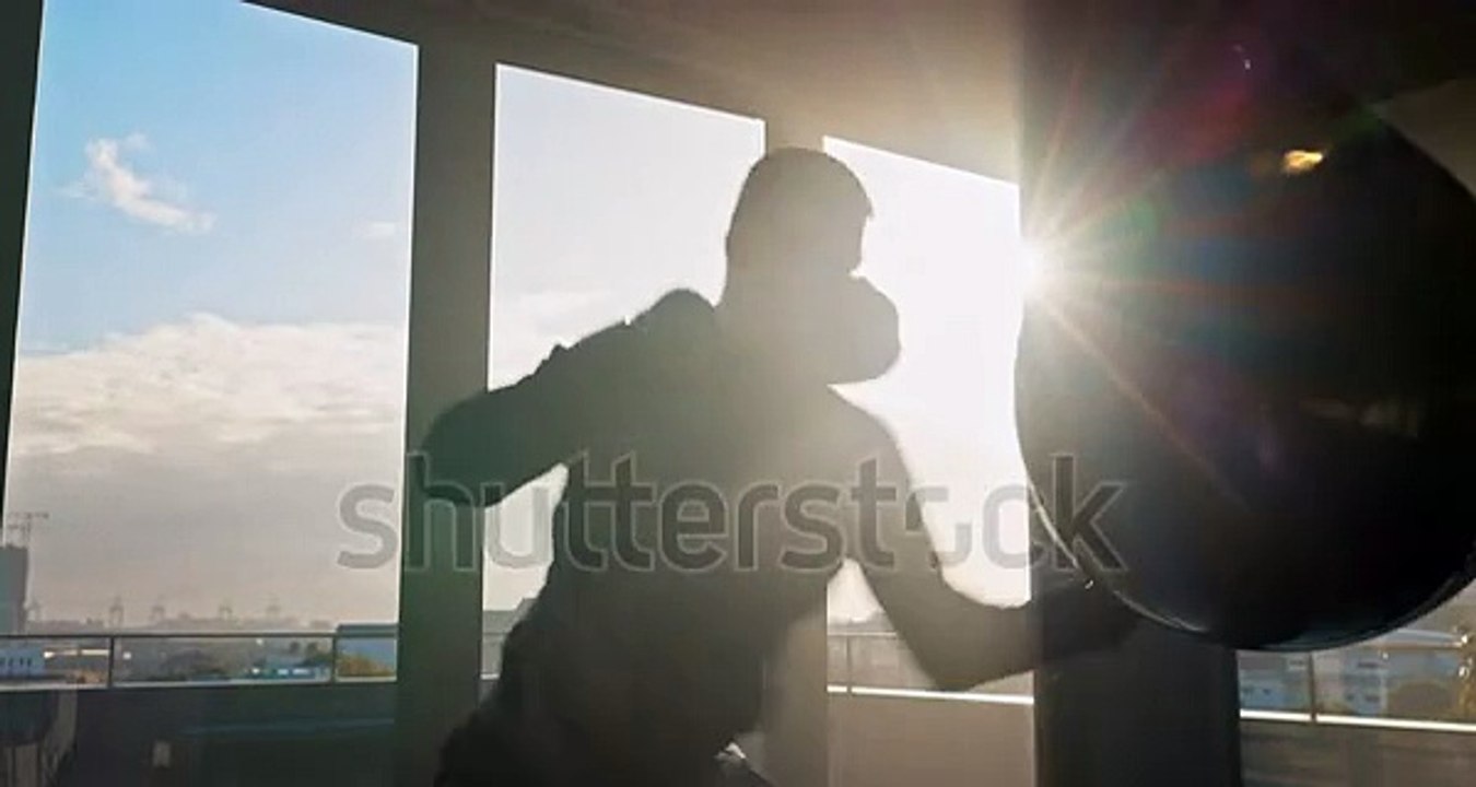 stock-footage-man-kickboxing-or-punching-bag-in-fitness-workout-or-training-of-stress-control-anger-management