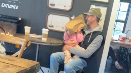 Little girl hides behind paper bag after seeing giant Easter Bunny at brunch