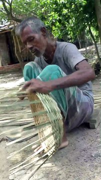 Hardworking old uncle Making Bamboo Basket in Village