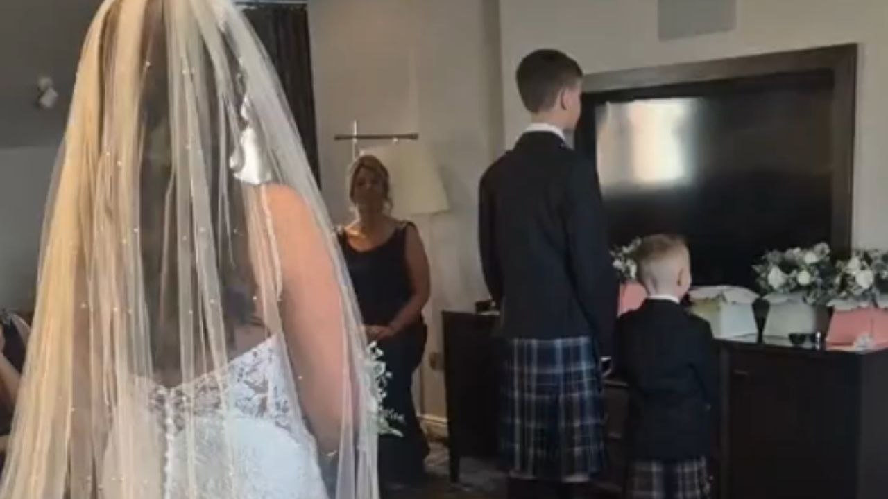 Boy sees his mom in wedding dress and breaks down in tears