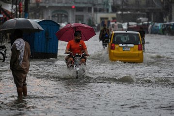 Rescuers on standby near swollen river in Pakistan after heavy rain