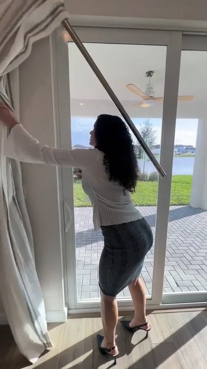 Woman Pulls Aside Curtains and Gets Hit On Head by Its Rod