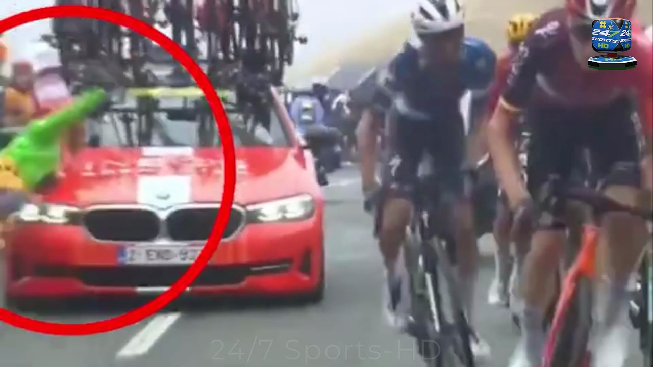 INEOS' team car knocks down a spectator on the road during the Tour de France mountain climb