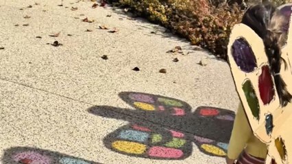 Little girls wear butterfly wings their mom made from cardboard