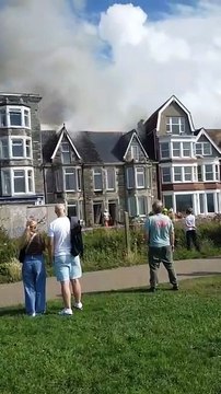 Crowds gathered as the fire took hold at the derelict property at Narrowcliff