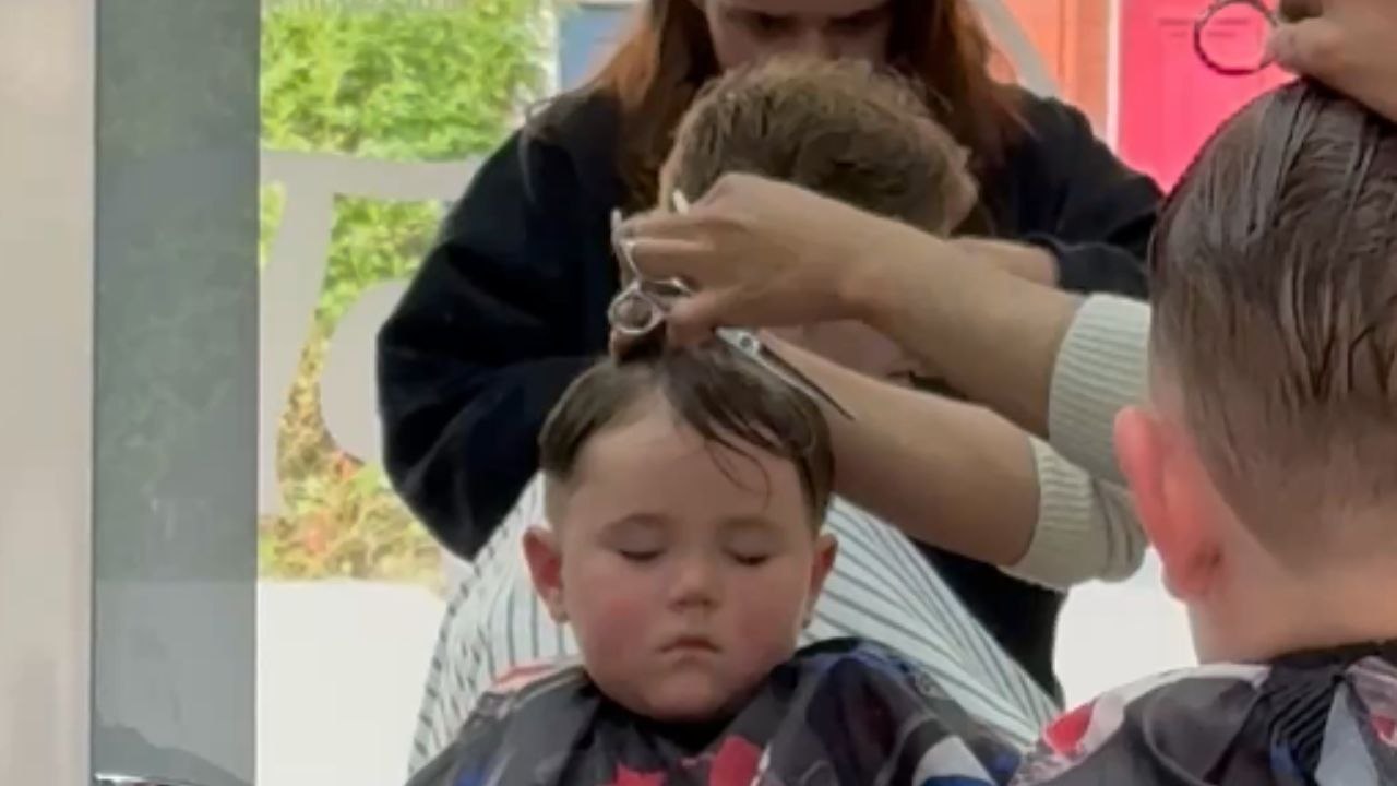 Little boy takes a nap while getting a haircut...