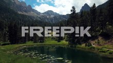 石塚昭典　aerial horizontal 4k footage of a lake in a green natural environment with mountains in the spanish pyrenees