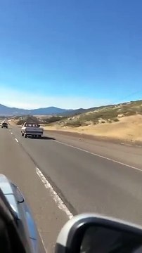 Creepy people wearing masks seen driving down highway in California