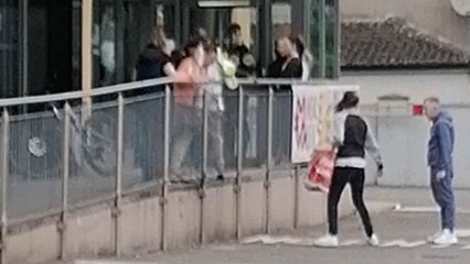 Two men wrestle outside McDonald's without landing a single punch