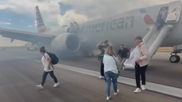 American Airlines passengers flee on emergency slide after Boeing plane wheel catches fire